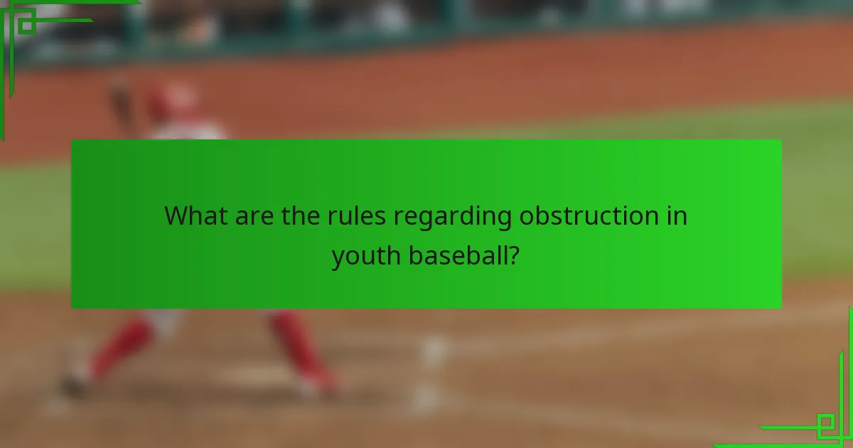 What are the rules regarding obstruction in youth baseball?